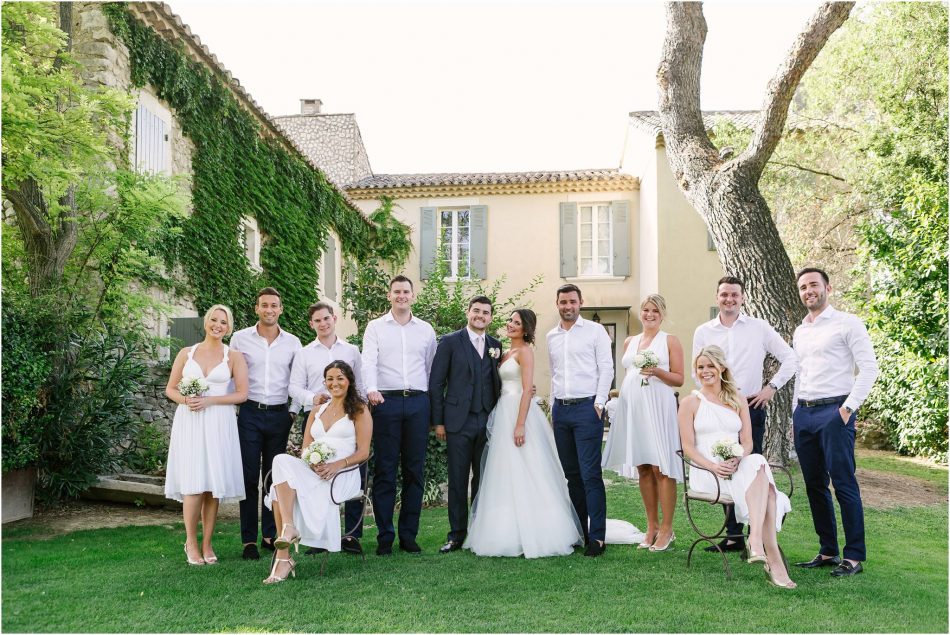 relaxed bridal party group photo in the gardens of Mas de las Rose