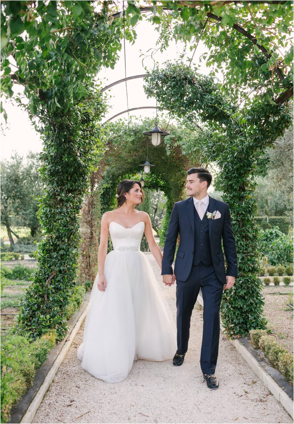 Mas de las Rose wedding photography; couple holding hands in herb garden