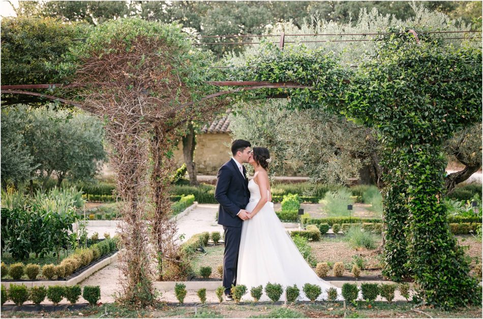 Bride and Groom kiss in the herb garden on their wedding day in Provence