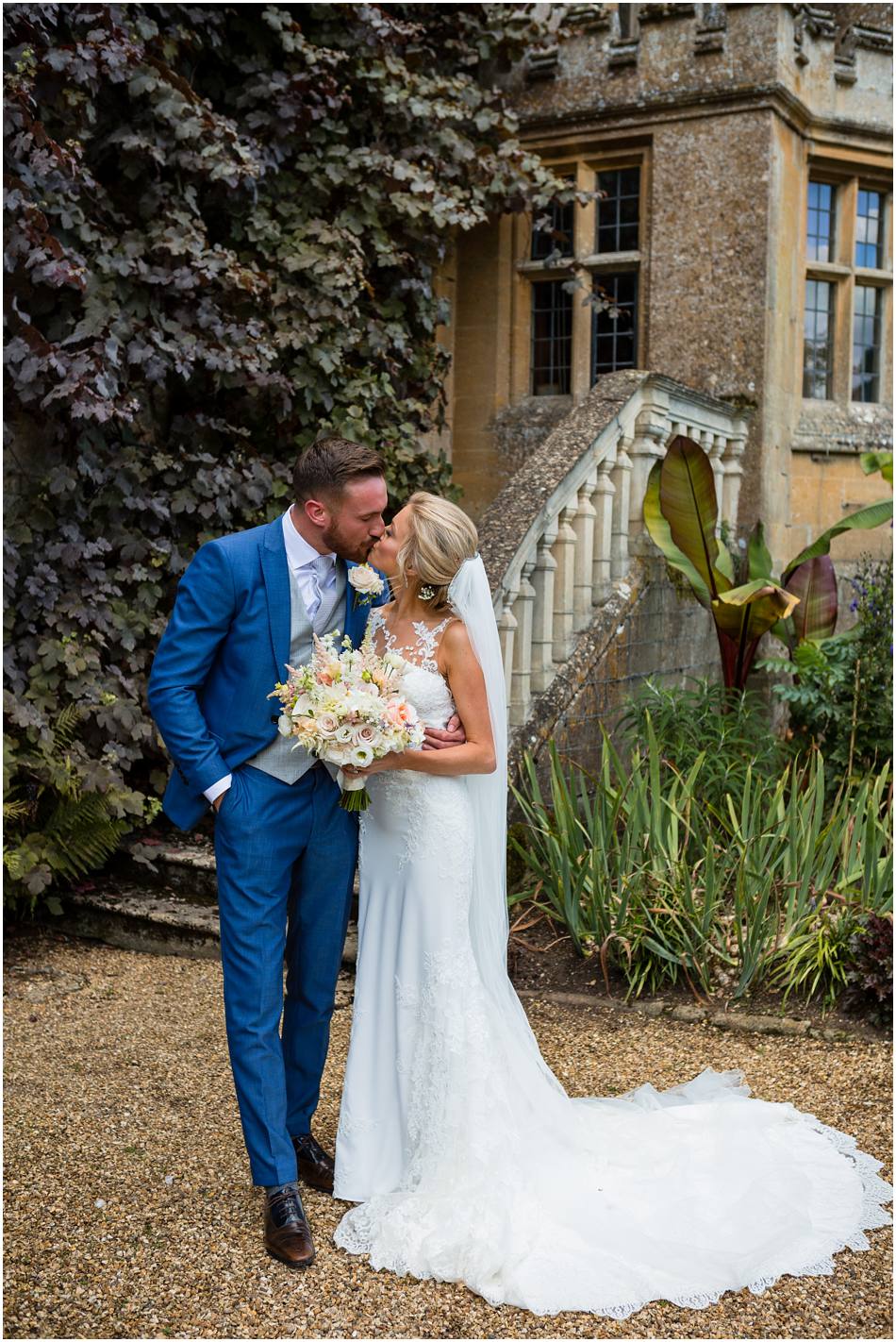 Newly married couple kiss; Sudeley Castle wedding photography