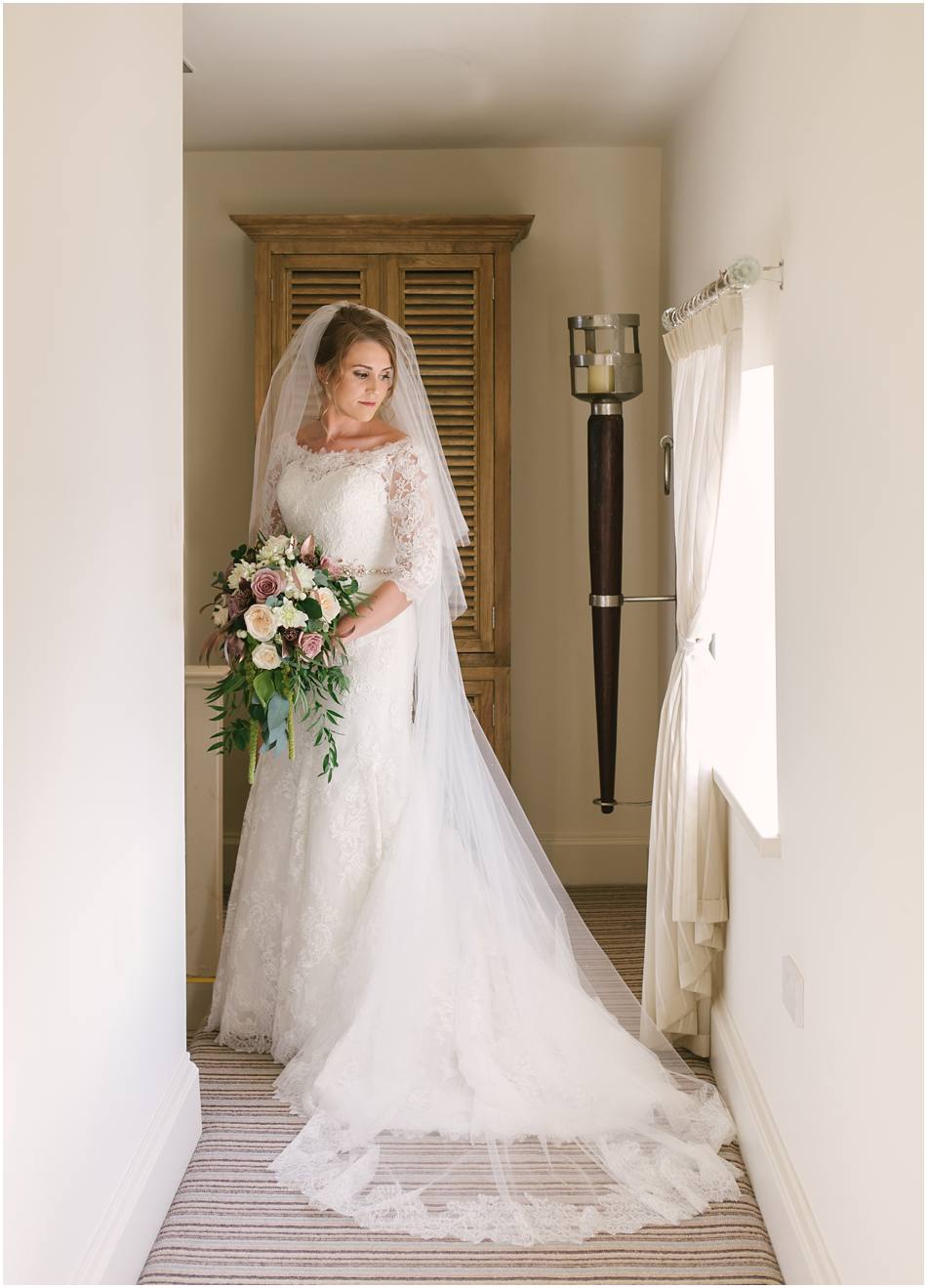 Modern Alrewas Hayes wedding; portrait of a Bride wearing a long sleeved lace wedding dress