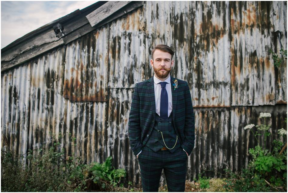 Portrait of a Groom with beard and dark green tartan check suit