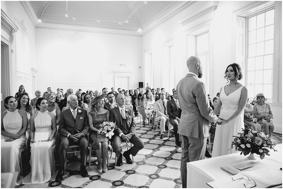 couple hold hands in during their civil wedding ceremony