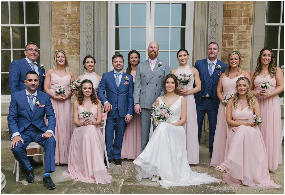 Compton Verney wedding photography; Modern group photo of the Bridal Party under the collonade