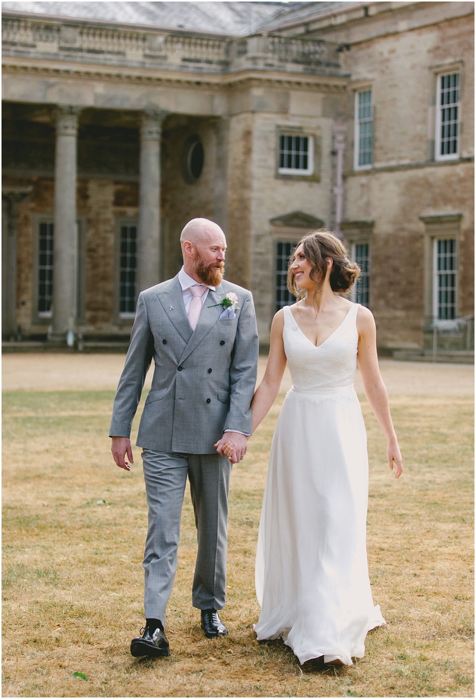 Compton Verney wedding photography;Bride and Groom walking in the grounds holding hands