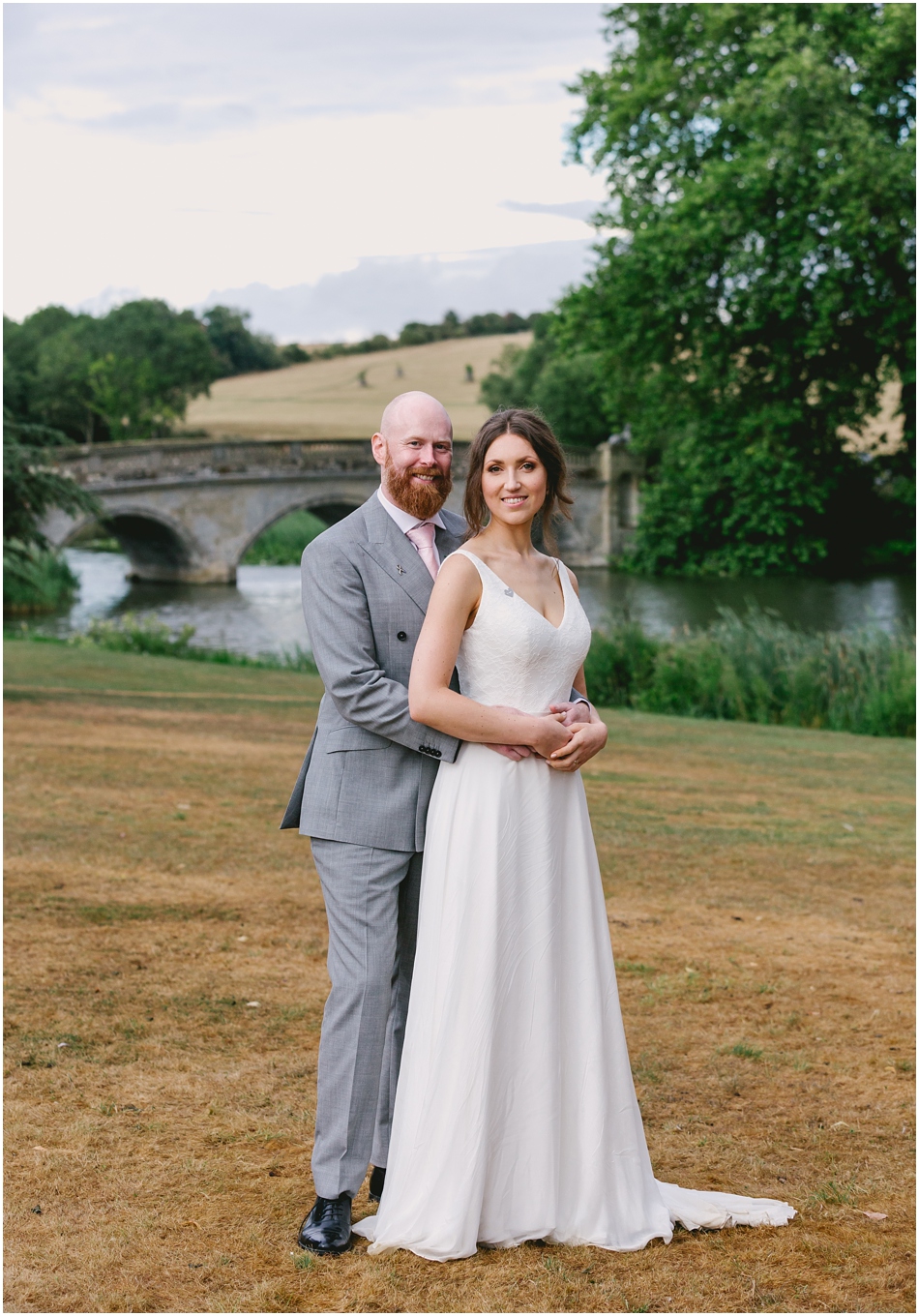 Bride and Groom in front of the bridge at their Compton Verney Wedding