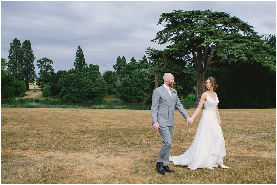 Bride and Groom walking in the grounds of Compton Verney