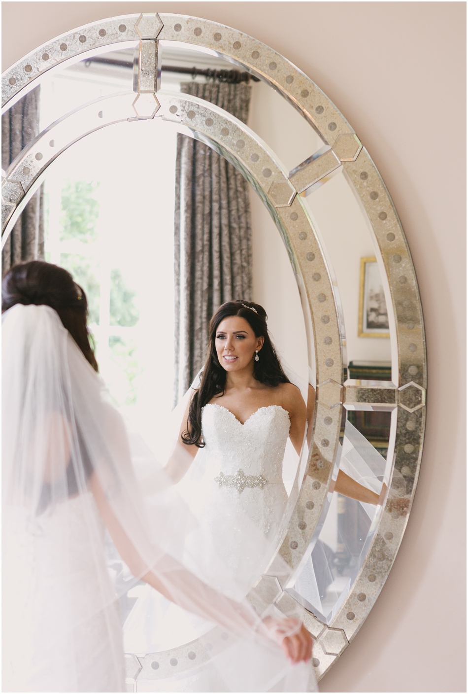 Romantic Iscoyd Park wedding; Bride looking in the mirror in the Bridal Suite