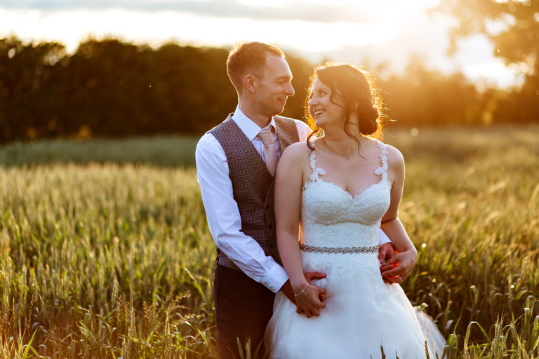 portrait of a Bride and Groom at golden hour in a corn field at Alrewas Hayes