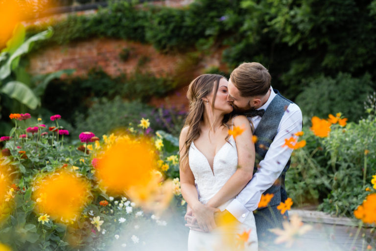 Bride and Groom kissing in gardens at Thorpe Garden wedding