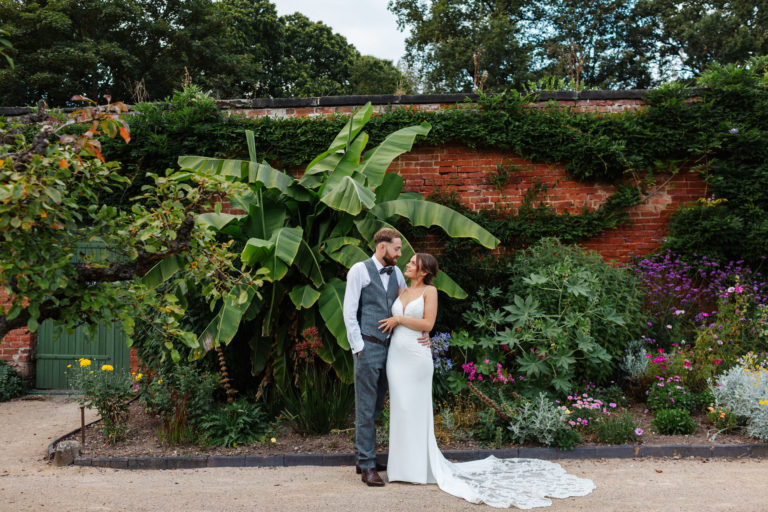 Thorpe Garden wedding photography: Bride and Groom standing in front of tropical plants