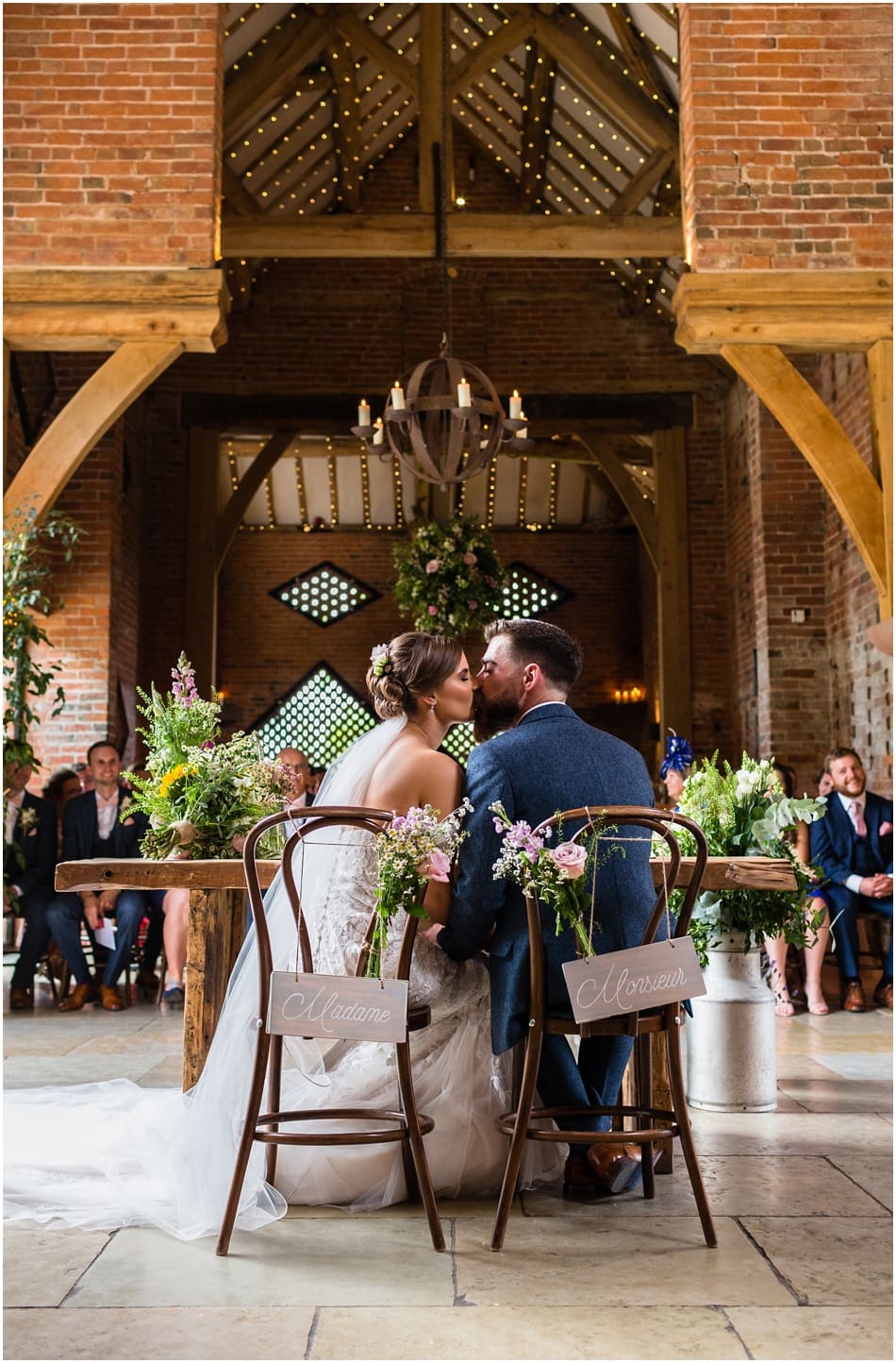 Shustoke Barn wedding photography; Bride and Groom kissing in their civil ceremony