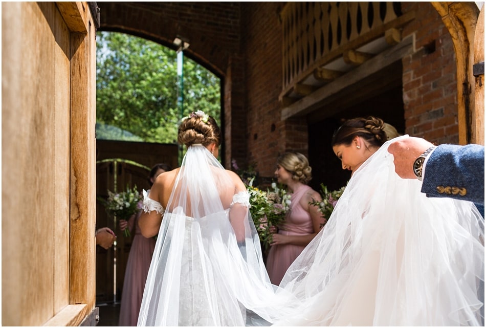 Bride entering Shustoke Barn on her wedding day