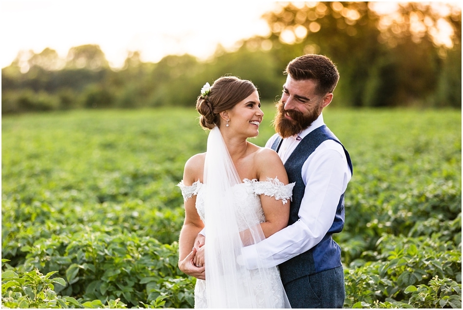 Shustoke Barn wedding photography; Bride and Groom portrait at sunset