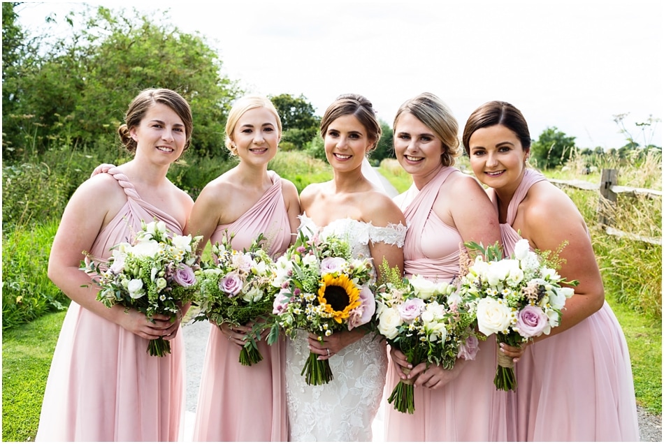 Shustoke Barn wedding photography; Bride with Bridesmaids in blush pink