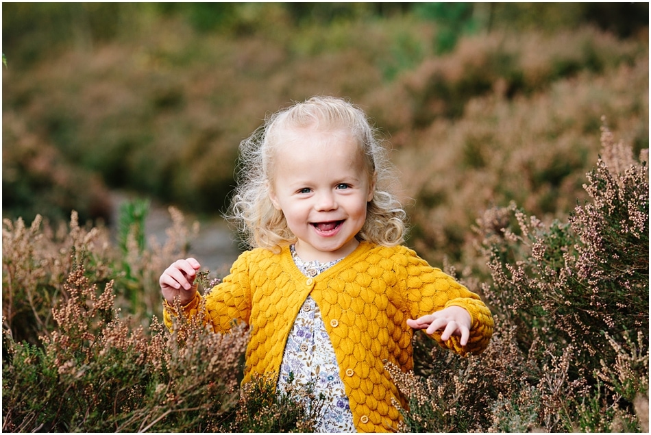 little girl laughing in the Autumn heather