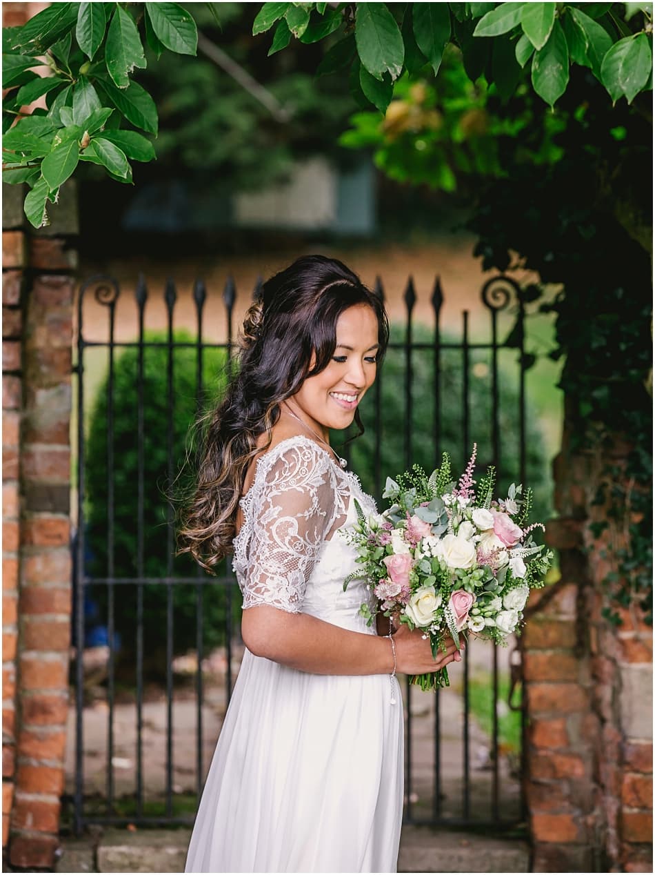 Gorcott Hall wedding photography; Bride wearing boho Dana Bolton wedding dress with pink and white rose bouquet