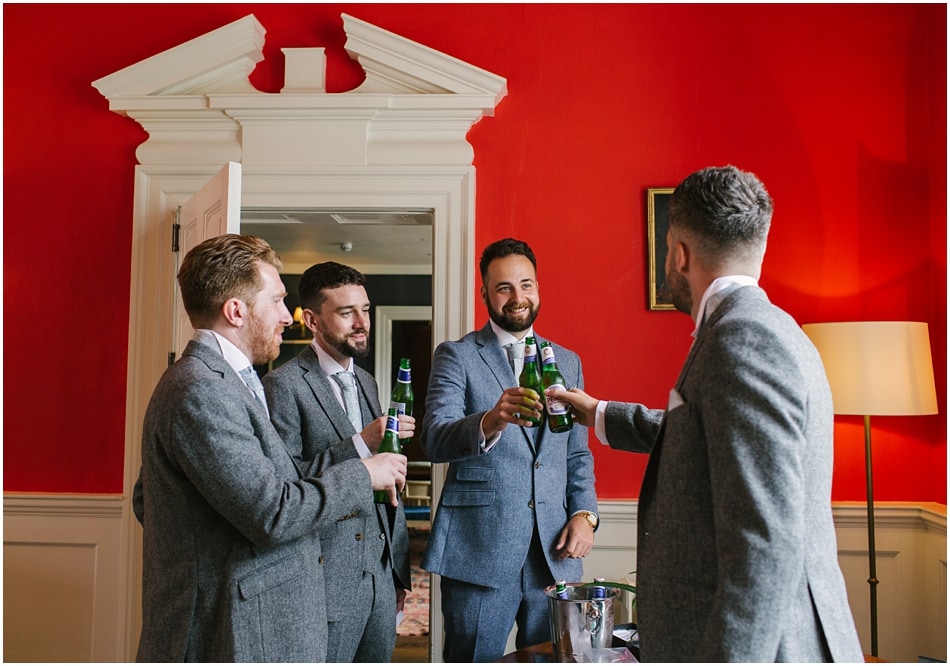 Iscoyd Park wedding photography | Groomsmen having a drink in the library