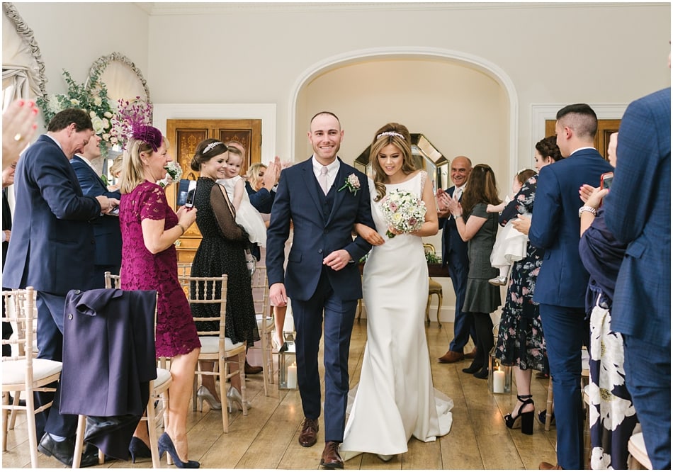 modern couple walking down the aisle