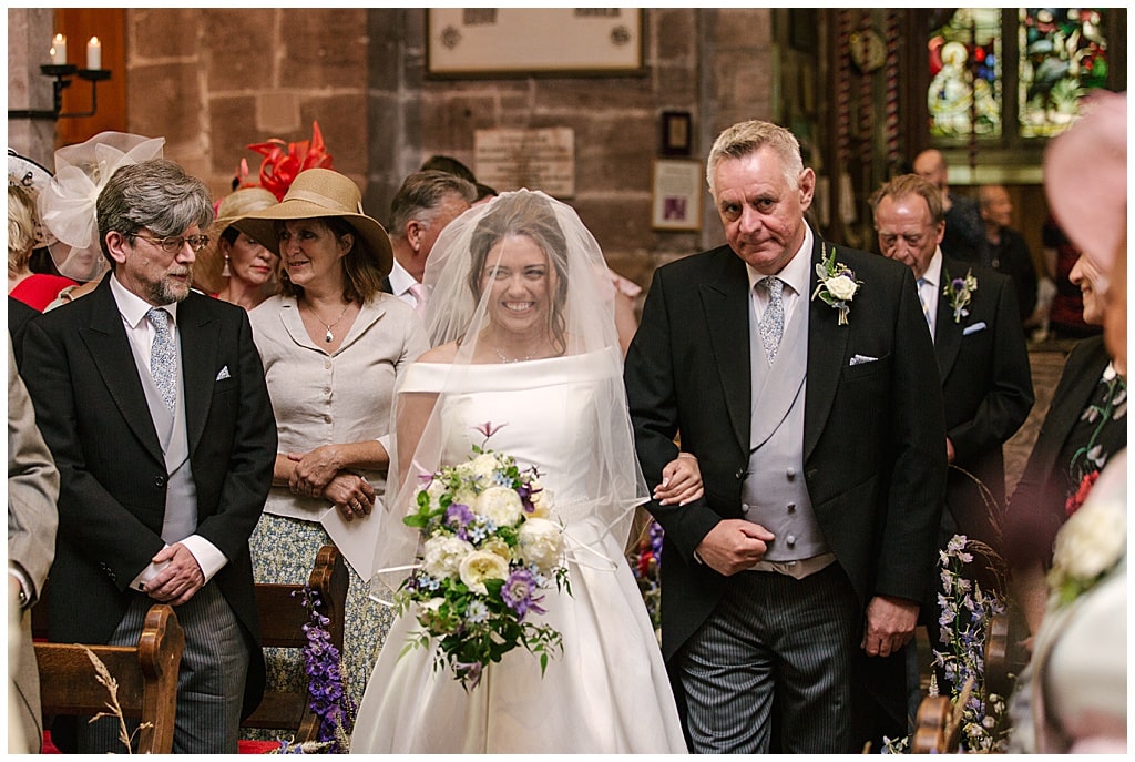 Bride walks down the aisle at a church wedding