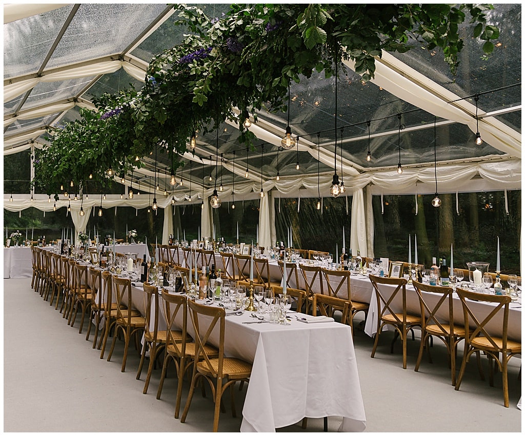 woodland clear marquee reception with Eddison light bulbs