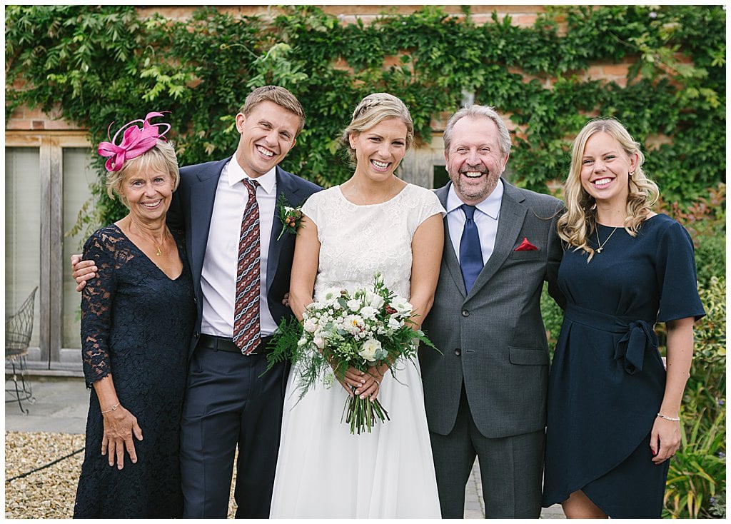 Relaxed, informal family group photo at a Small wedding at Eckington Manor