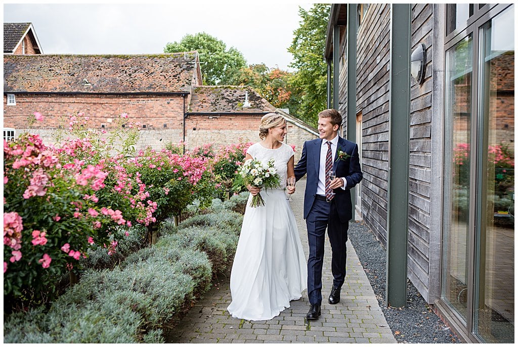 Natural candid photo of a Bride and Groom walking during their wedding reception