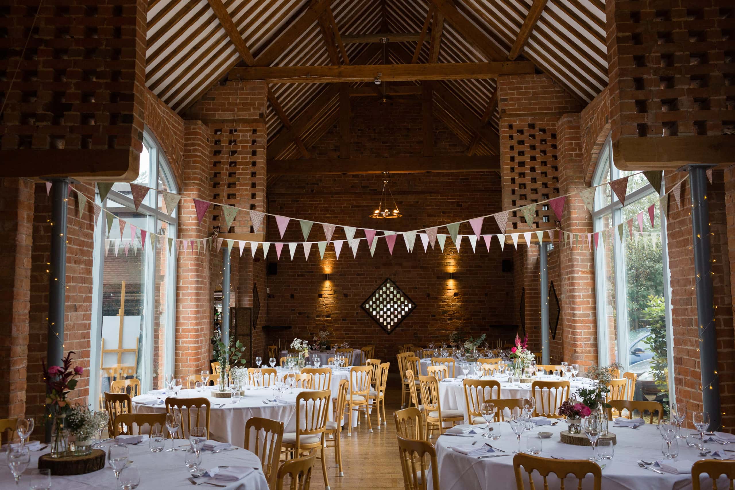 Interior of Swallows Nest Barn with pretty bunting ready for wedding meal