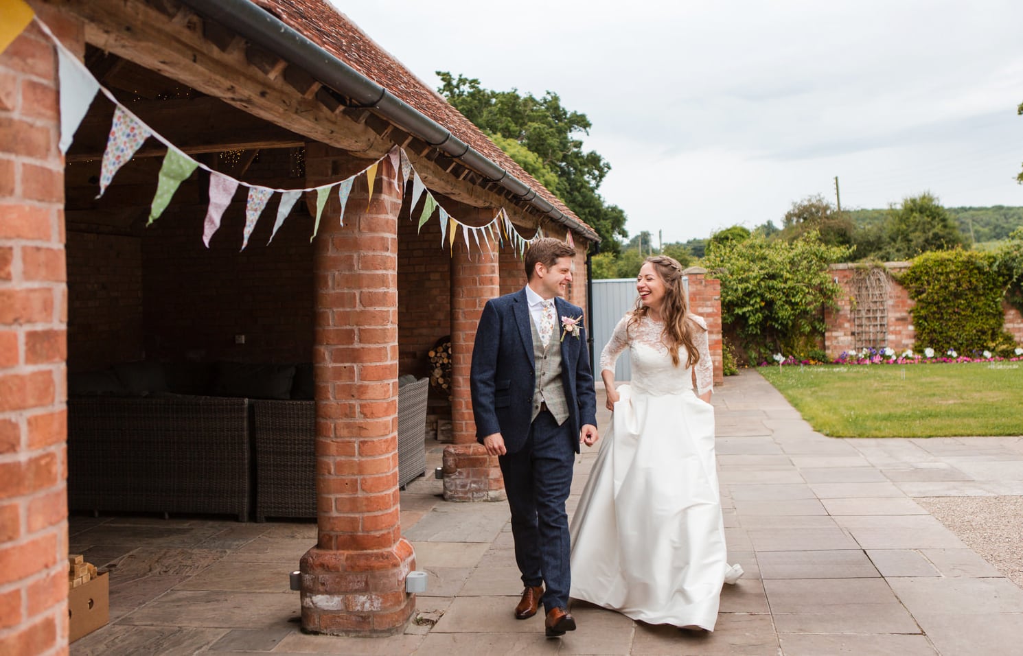 relaxed couple walking in the courtyard at Swallows Nest Barn