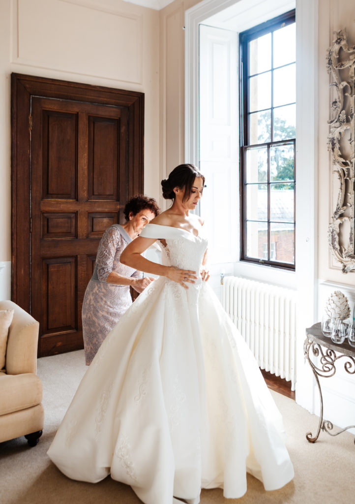 Davenport House wedding photography; Bride getting ready in the Bridal Suite, helped by her Mum