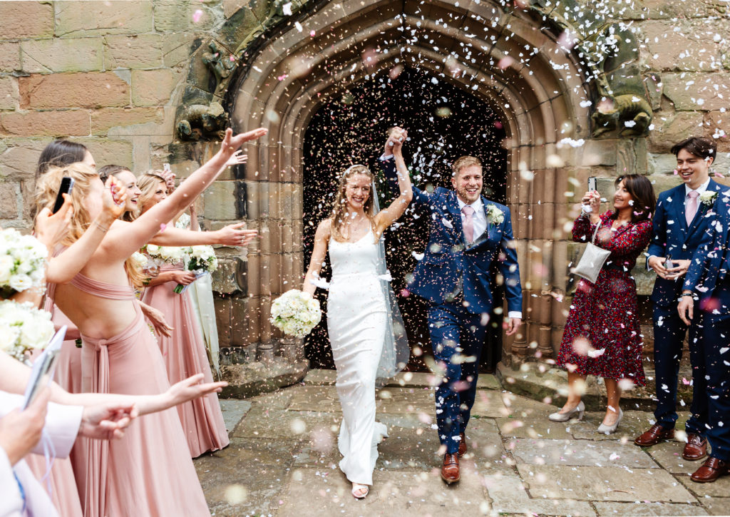 Confetti photo of Bride and Groom leaving church after their wedding in Birmingham