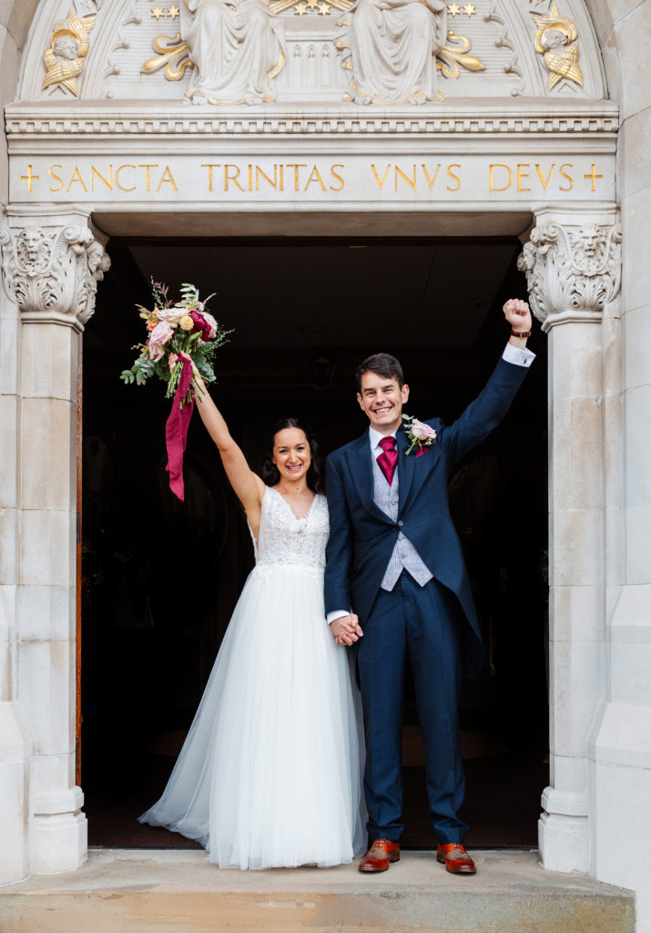 Sutton Coldfield wedding photography; Happy couple outside Holy Trinity Church 