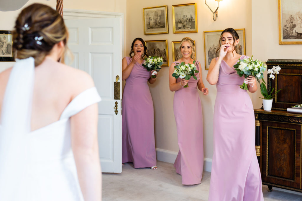 Bridesmaids seeing Brides dress for the first time in Iscoyd Park Bridal Suite