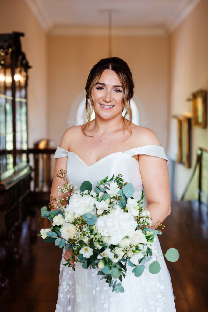 Iscoyd Park wedding photography; portrait of Bride in the hallway with classic ivory bouquet