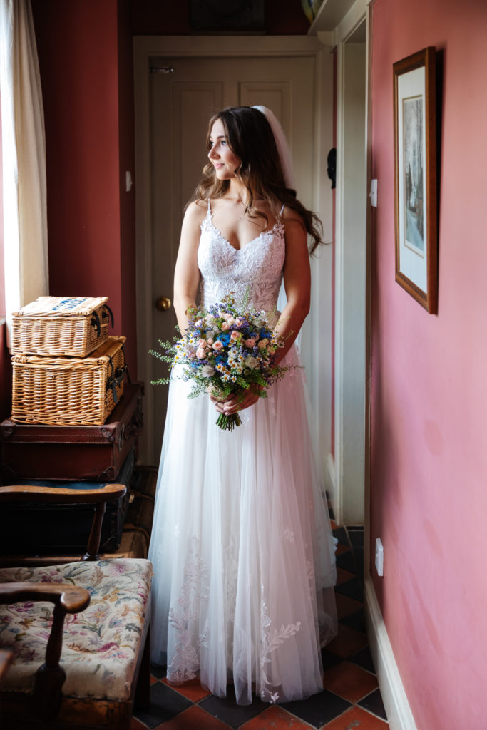 Thorpe Garden wedding photography; Bride in a boho style wedding dress with country flower bouquet