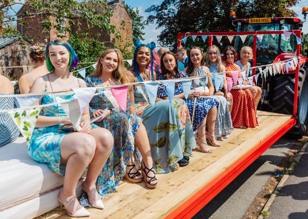 Fun wedding group photo on tractor