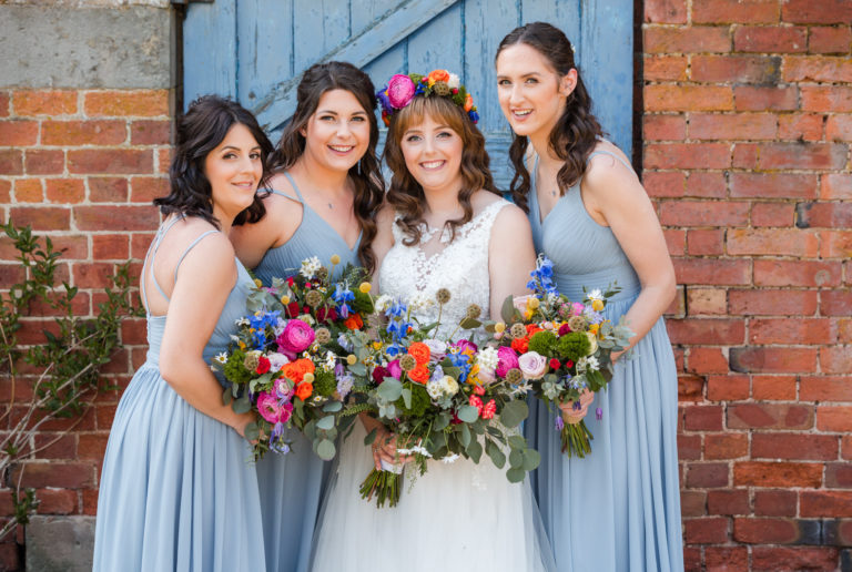 Bridesmaids with colourful bouquets and flower crown at Thorpe Garden Wedding