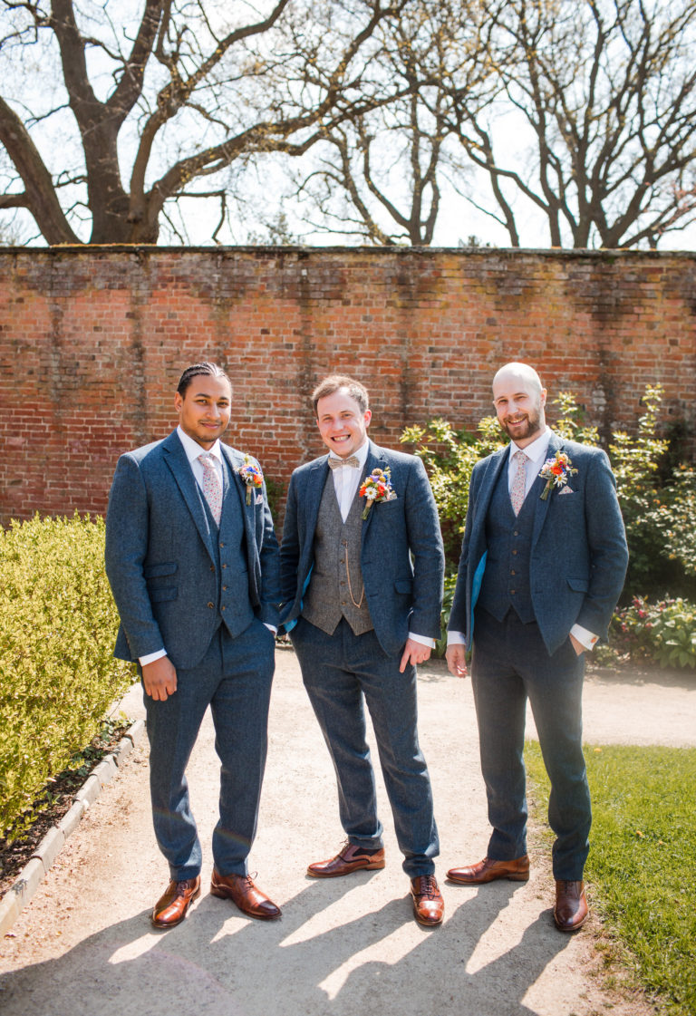 Groom standing with two Best men, wearing blue tweed suits at a Thorpe Garden wedding