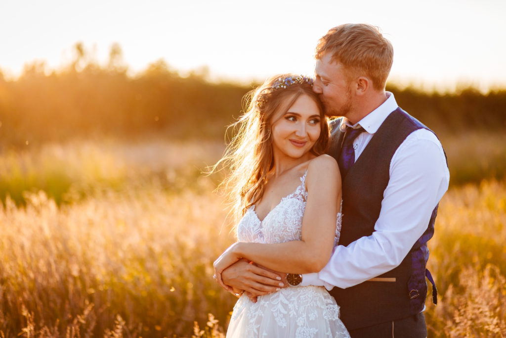 Boho Bride and Groom wedding portrait at sunset in a cornfield in Warwickshire