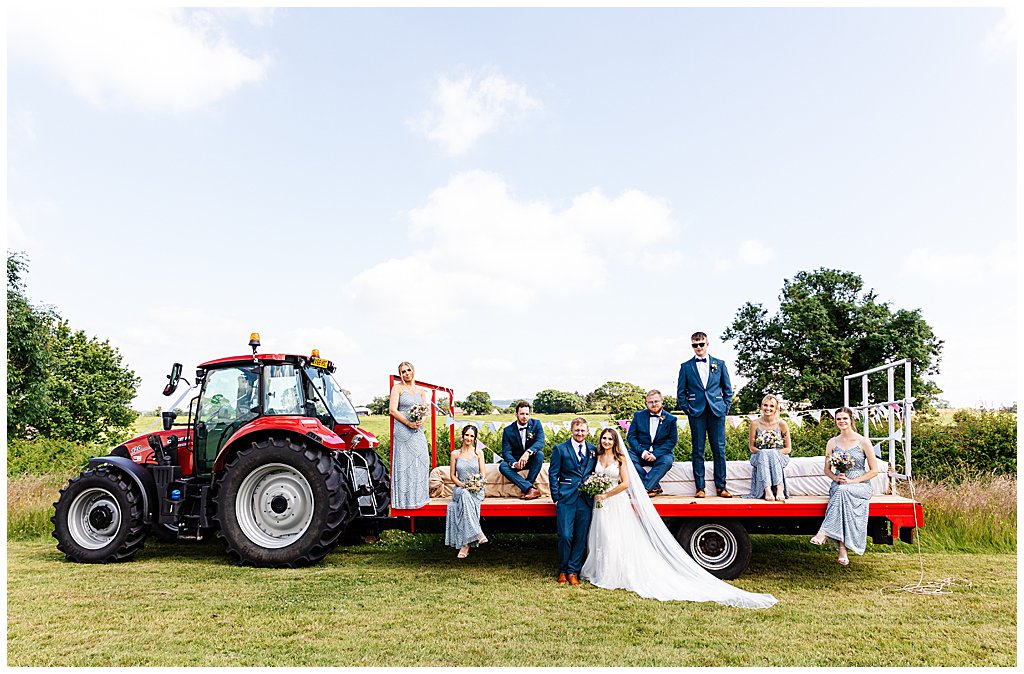 Fun bridal party group photo on a tractor trailer