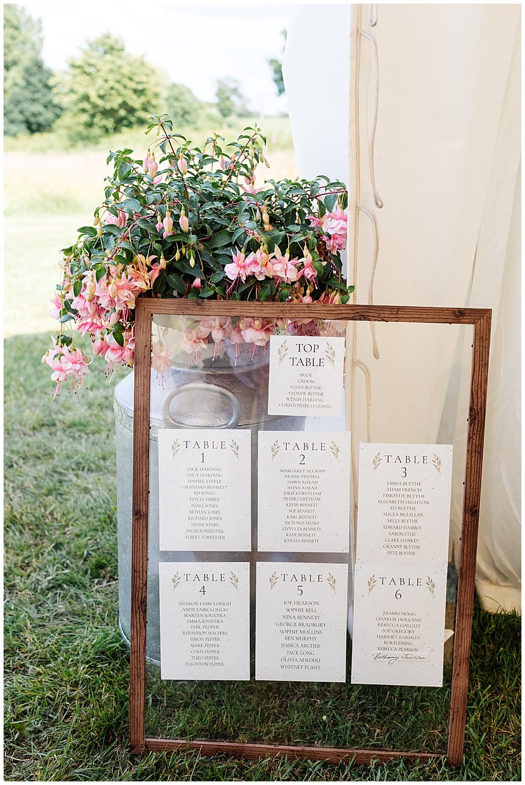 rustic window pane table plan agains flower filled milk churn