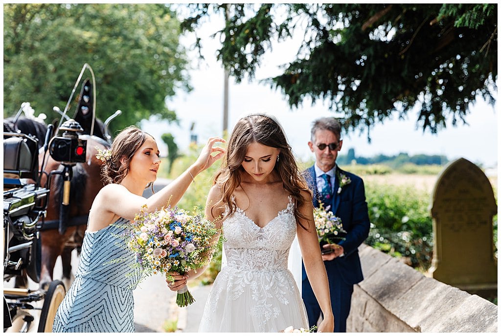 Bride arriving at Smallwood Church wedding with country flowers bouquet