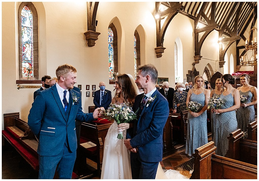 Groom sees his Bride for the first time at the end of the aisle in Smallwood Church