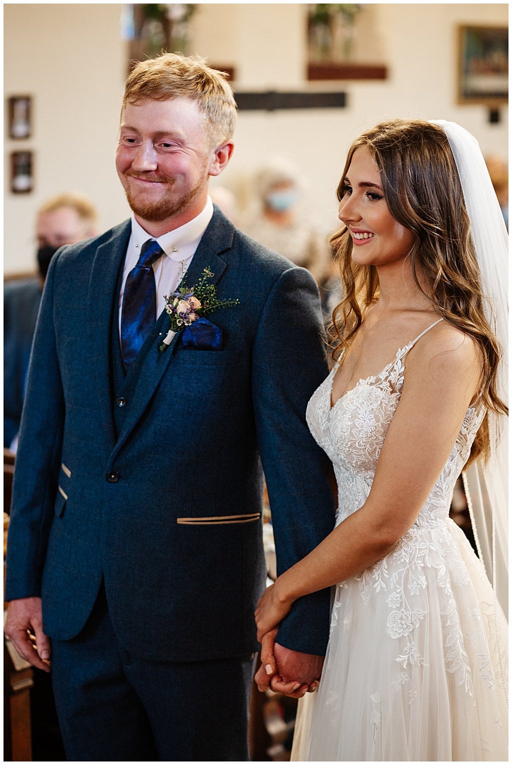 Bride and Groom stand holding hands inside Smallwood Church