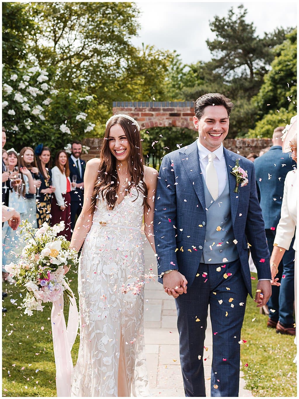 walking confetti photo of a Bride and Groom at Alrewas Hayes in the Summer