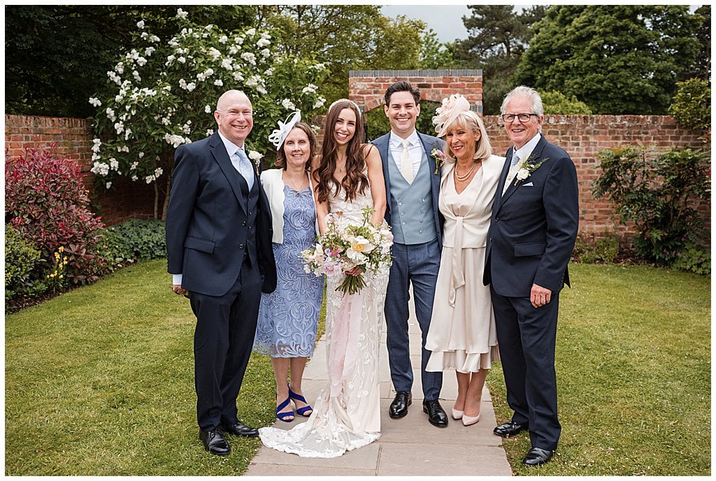 Relaxed, happy family group photo at Alrewas Hayes, Bride and Groom with their parents