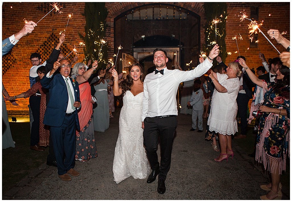 Sparkler photo at Shustoke barn. Bride and Groom sparkler exit