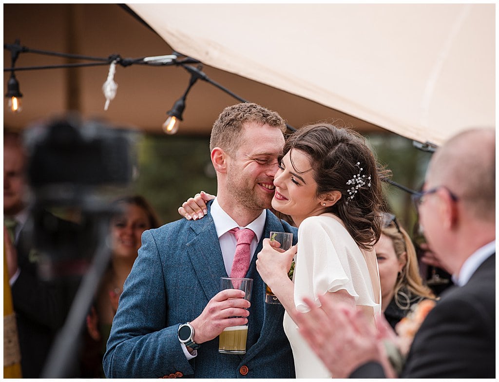 casual candid photo or Bride and Groom during speeches outside at Pimhill Barn