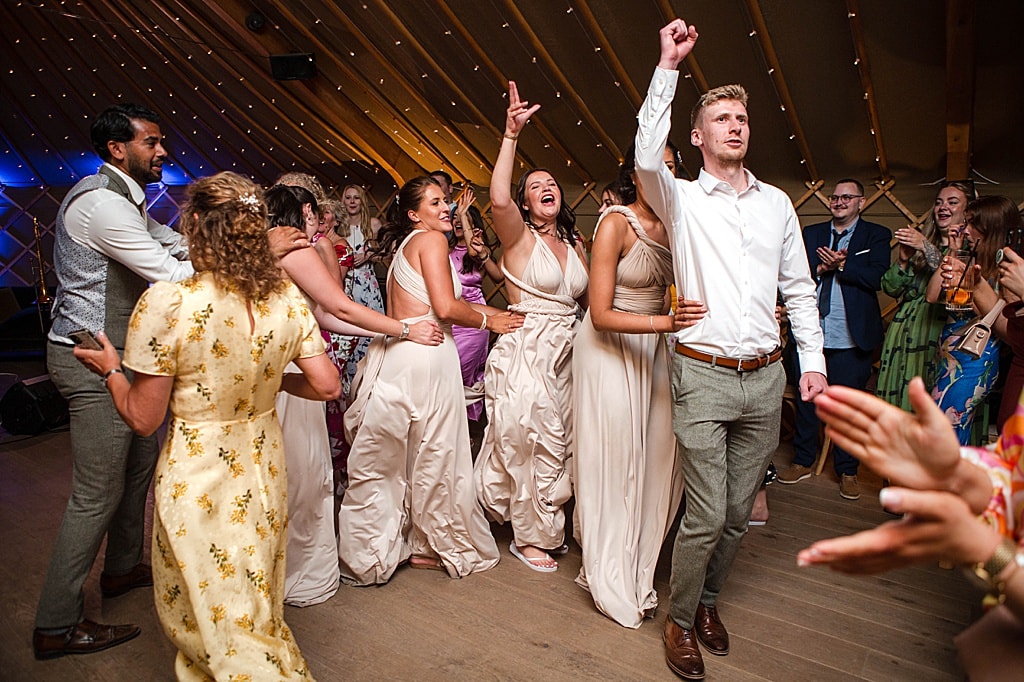 wedding guests doing the conga