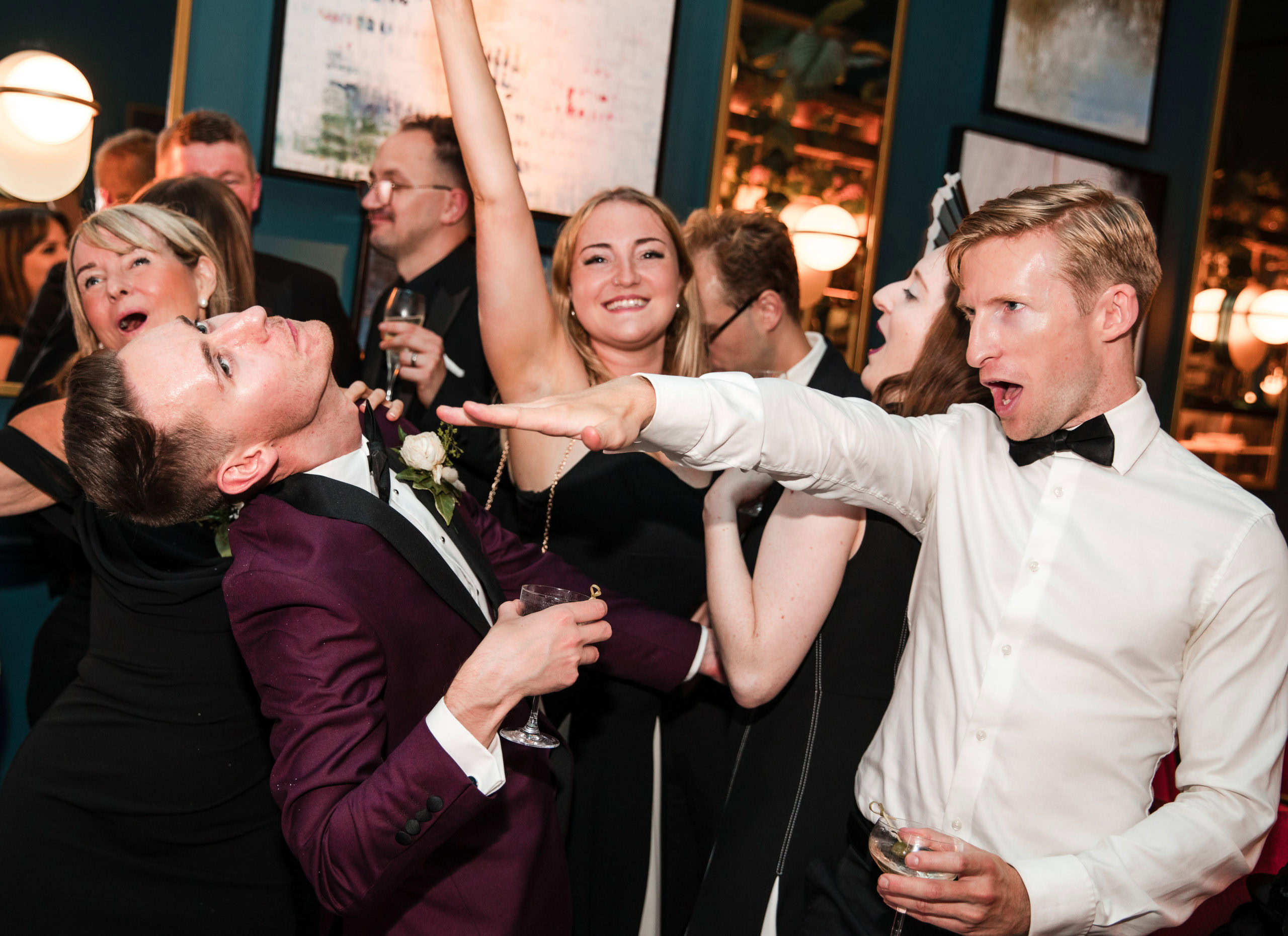 Candid photo of wedding guests having fun after a wedding in the city centre by a Birmingham wedding photographer